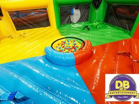The interior of the inflatable Hungry Hippos arena with red, blue, green and yellow quadrants around the central ball pit