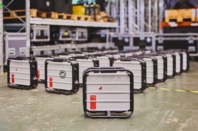 A single Instagrid ONE Max battery unit with the fleet of identical units stored behind it