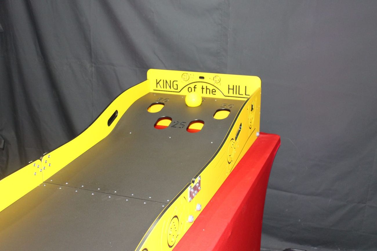Close-up of the King of the Hill scoring holes with a single ball resting at the top