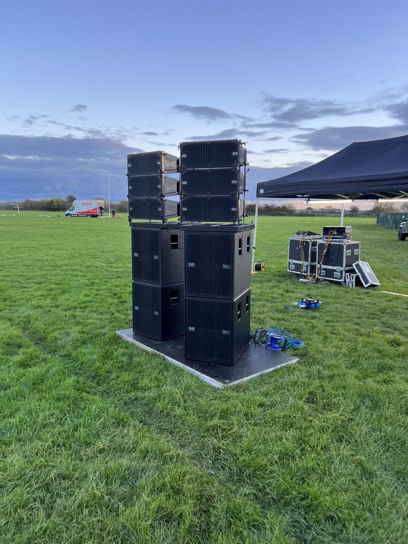 Large outdoor PA speaker stack with subwoofers and upper speaker arrays from the wider sound inventory