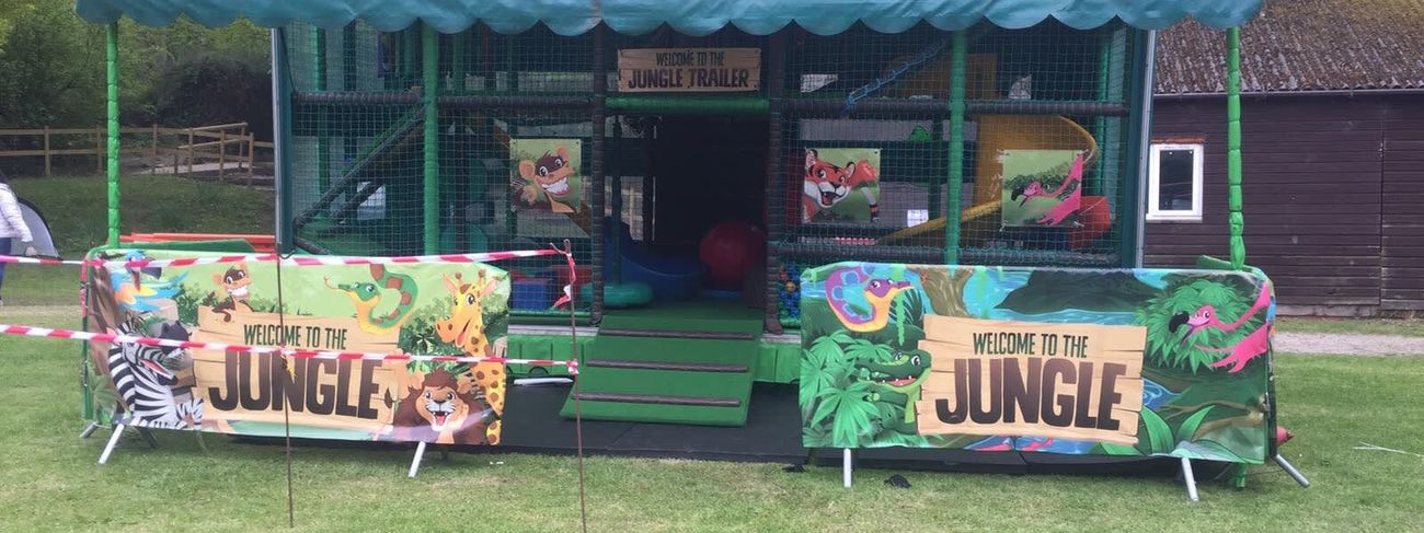 Trailer set up on grass with jungle banners