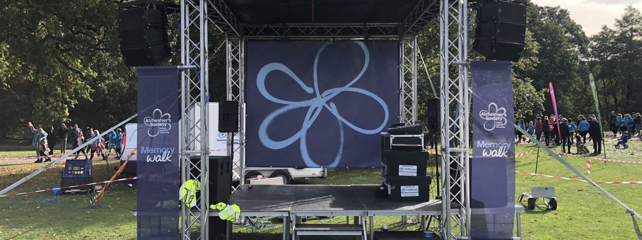 Branded mini stage set up for Memory Walk in park