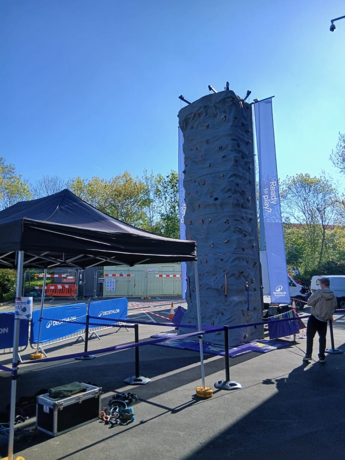 Harnesses laid out ready beside the climbing wall at the Decathlon Playdays activation