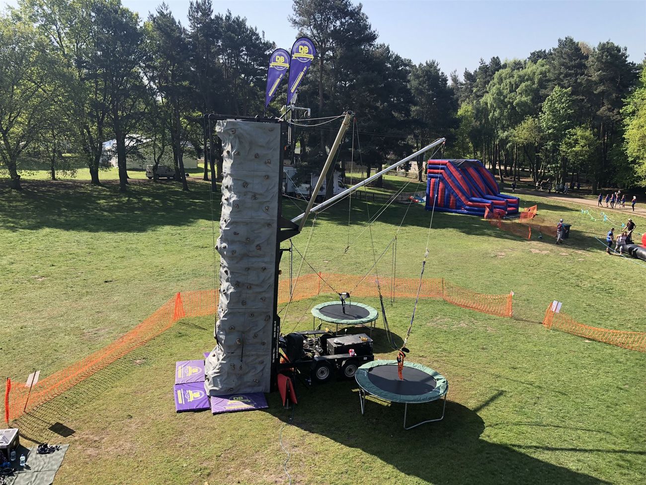 The mobile climbing wall with two bungee trampolines attached to its rear