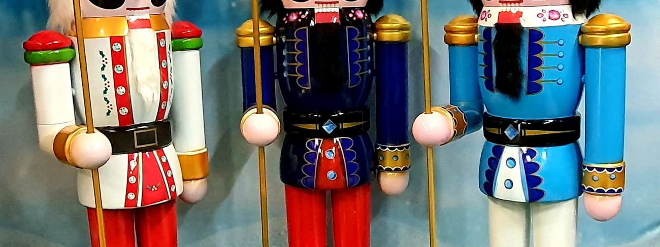 Three 6ft nutcracker figures in red, blue, and light blue uniforms