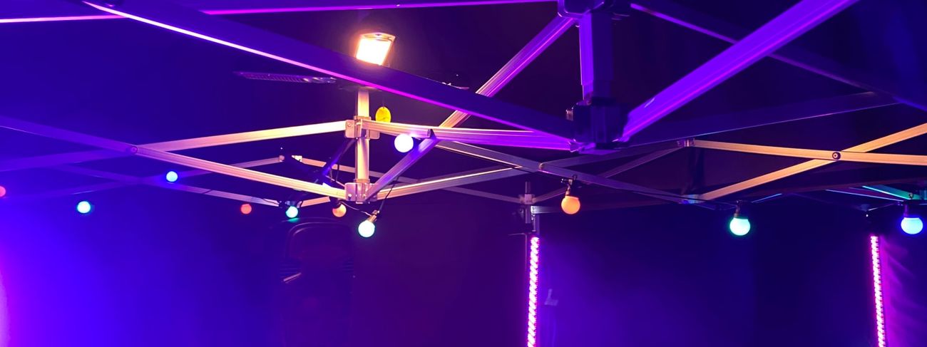 Purple and blue party lighting fitted around a marquee frame