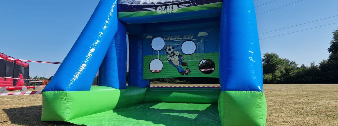 Player striking a football at a target goal with a speed radar display showing the shot speed