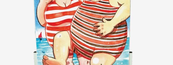 Painted face-in-the-hole board showing two seaside bathers in striped Victorian swimsuits paddling in the sea