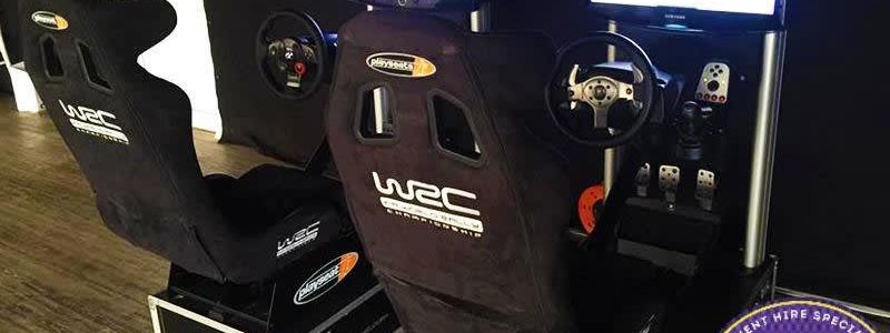 Twin Playseat WRC racing car simulator rigs with steering wheels and screens set up indoors