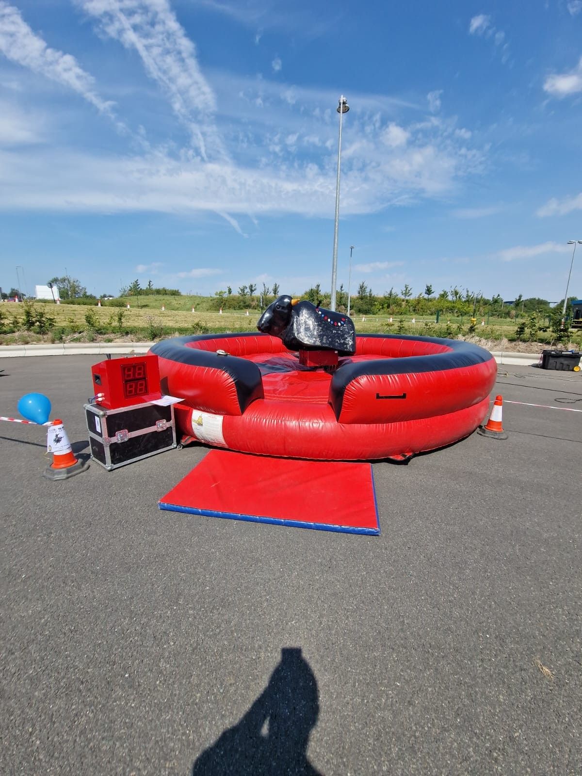 Black mechanical bull with dual digital timer, control equipment and padded entrance mat