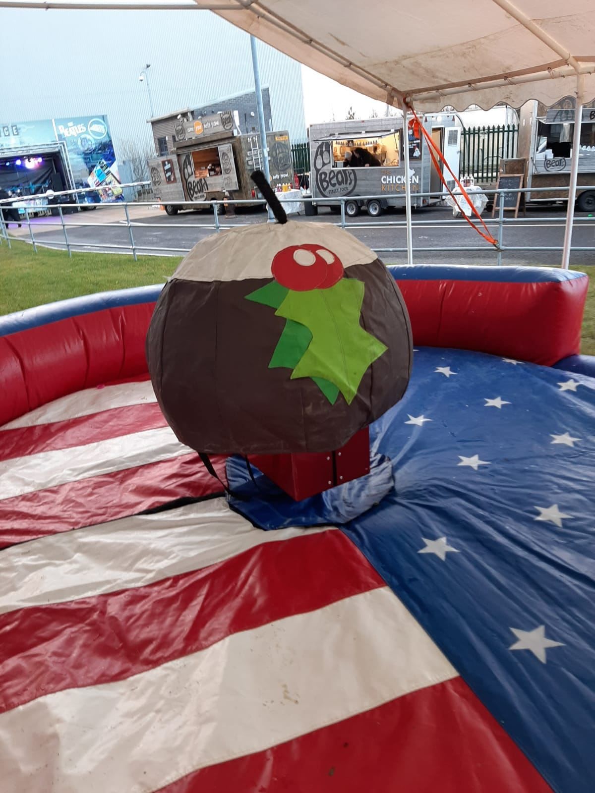 Holly-trimmed rodeo Christmas pudding on its red, white and blue inflatable safety bed