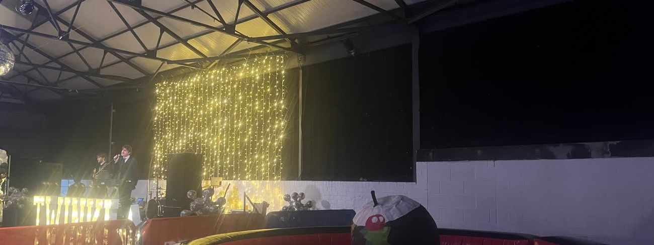 Rodeo Christmas pudding inside its red-and-black inflatable surround at an evening event