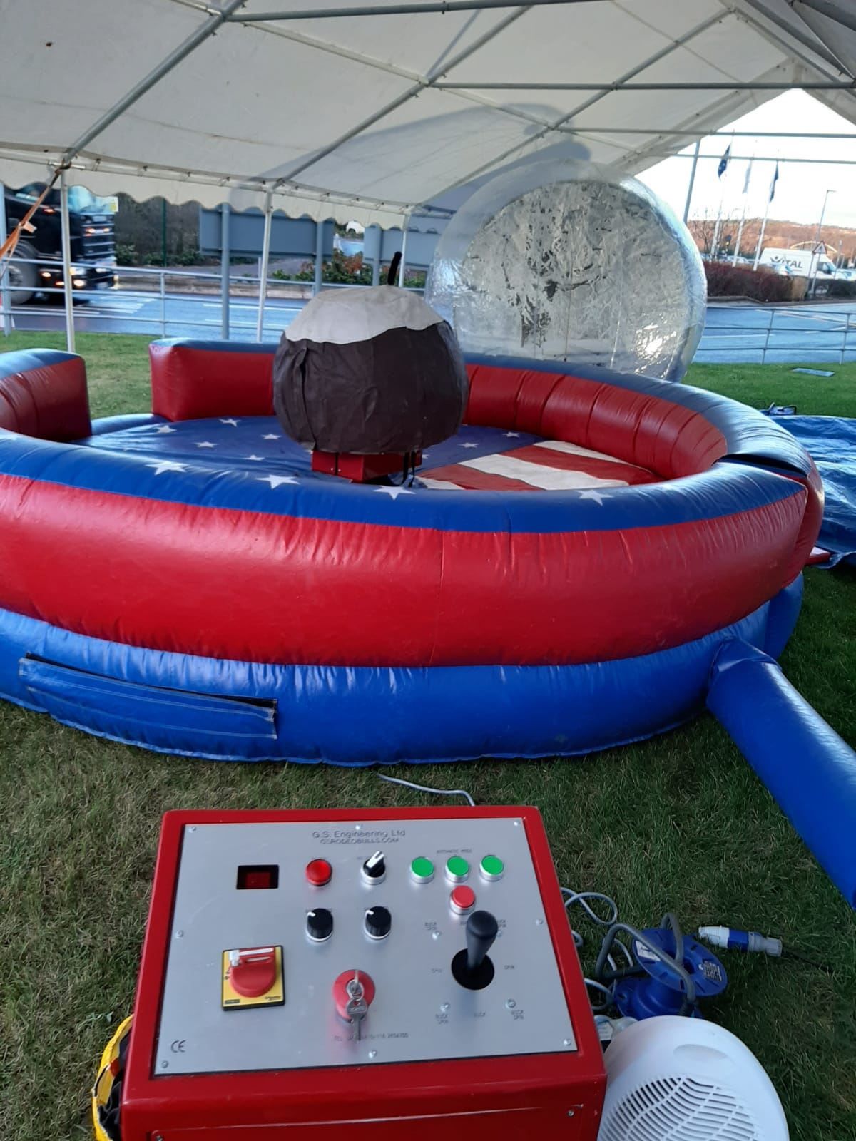 GS Engineering rodeo control station with joystick, speed controls and emergency stop beside the Christmas pudding ride
