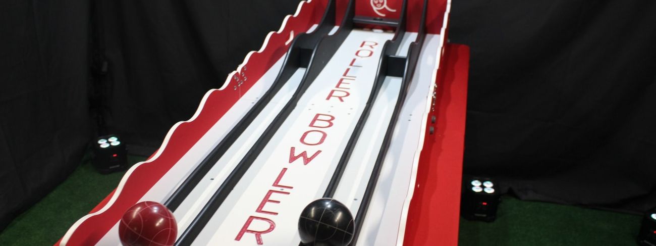 Two-lane Roller Bowler in red and white - both balls in the starting cradles, studio shot from above