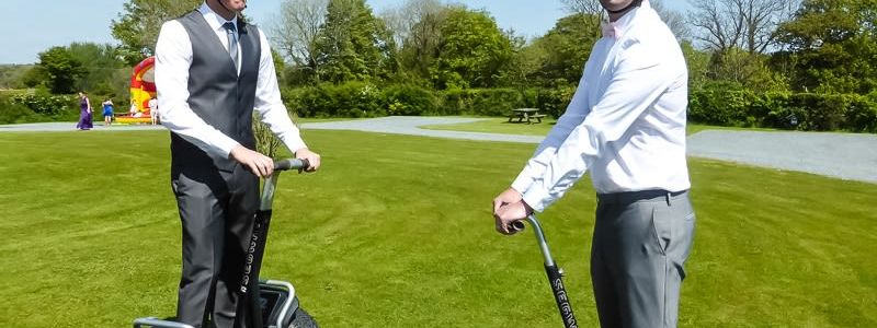 Two Segway X2s ready on a sunny lawn