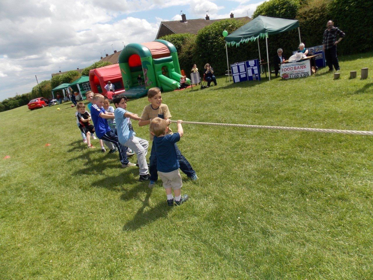 A team digging in and heaving on a thick competition rope at a corporate sports day