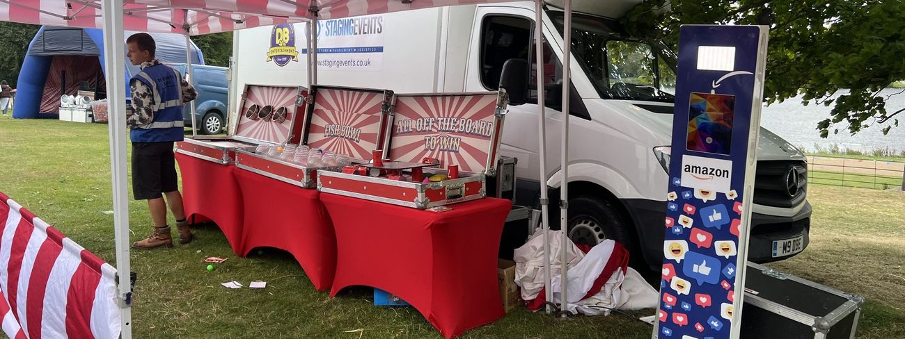 Branded social media photo booth surrounded by carnival stalls at an Amazon event